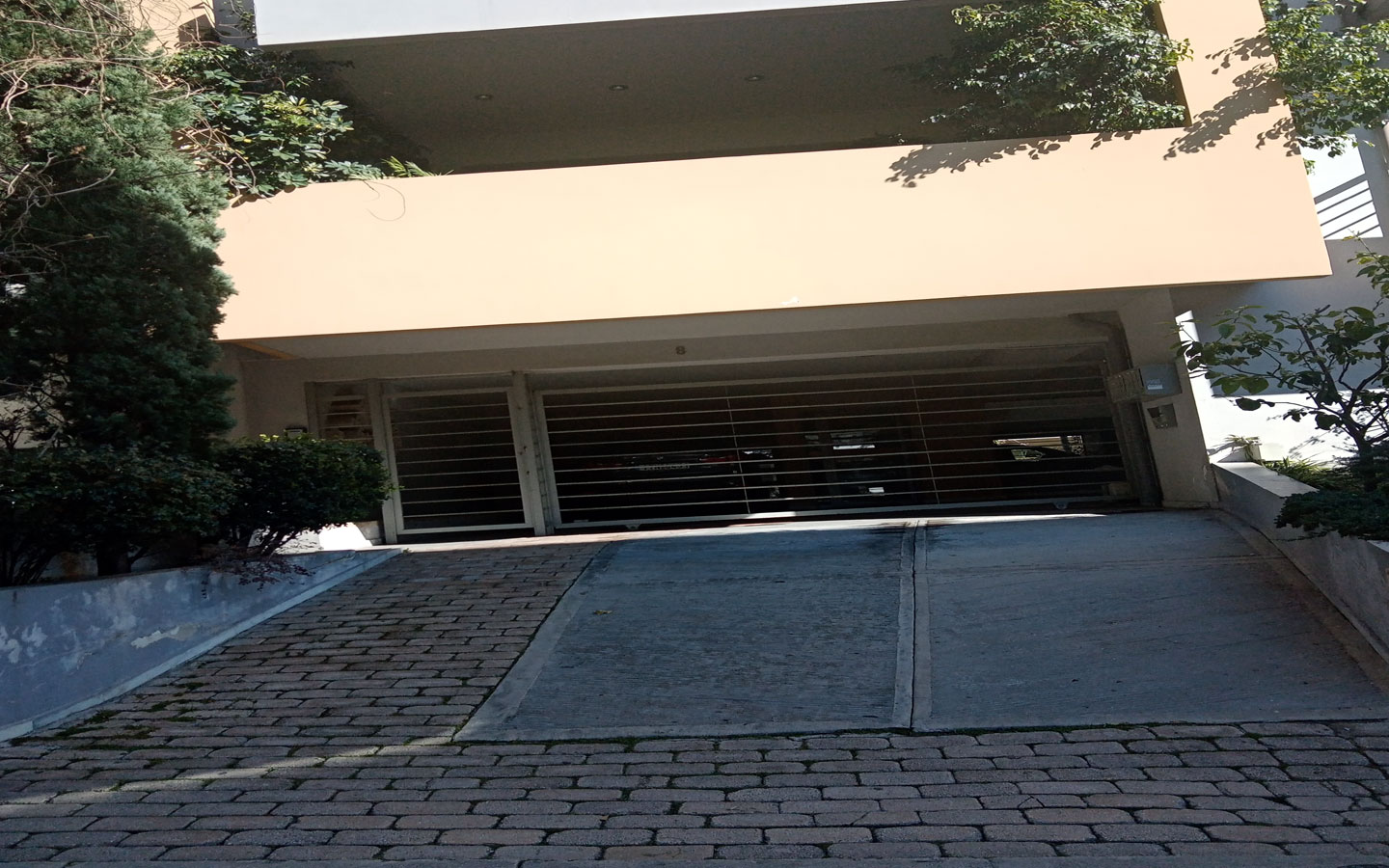 44 Entrance of the apartment building and of parking area